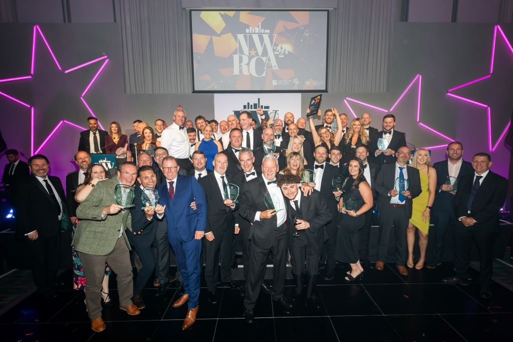 A group of award winners celebrate in their black tie attire