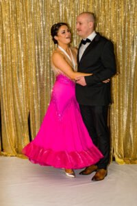 A couple in a tux and pink ball room dress