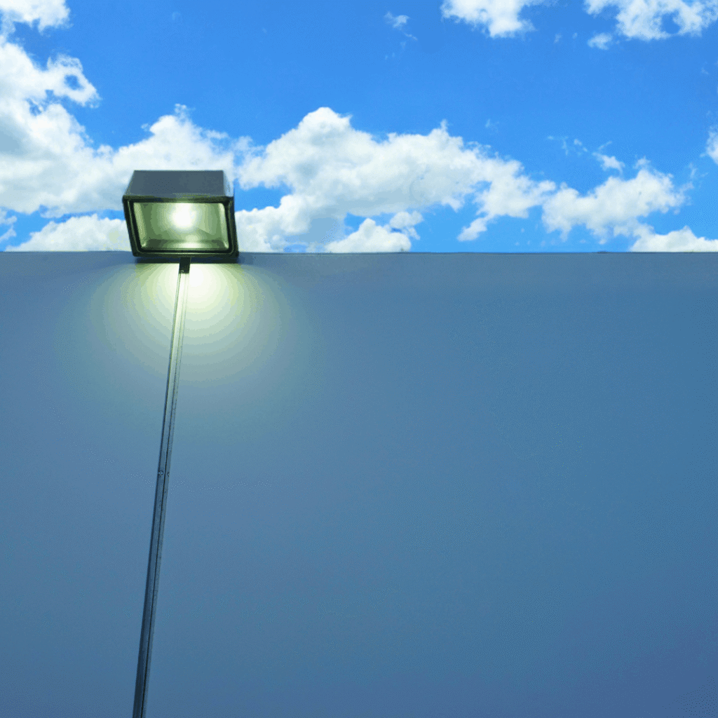 A highly lit carpark of a school which uses bright white light.