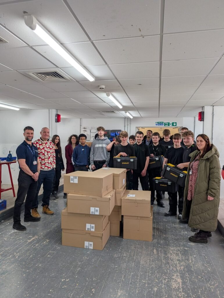 A pile of boxes in the middle of a crowd of people