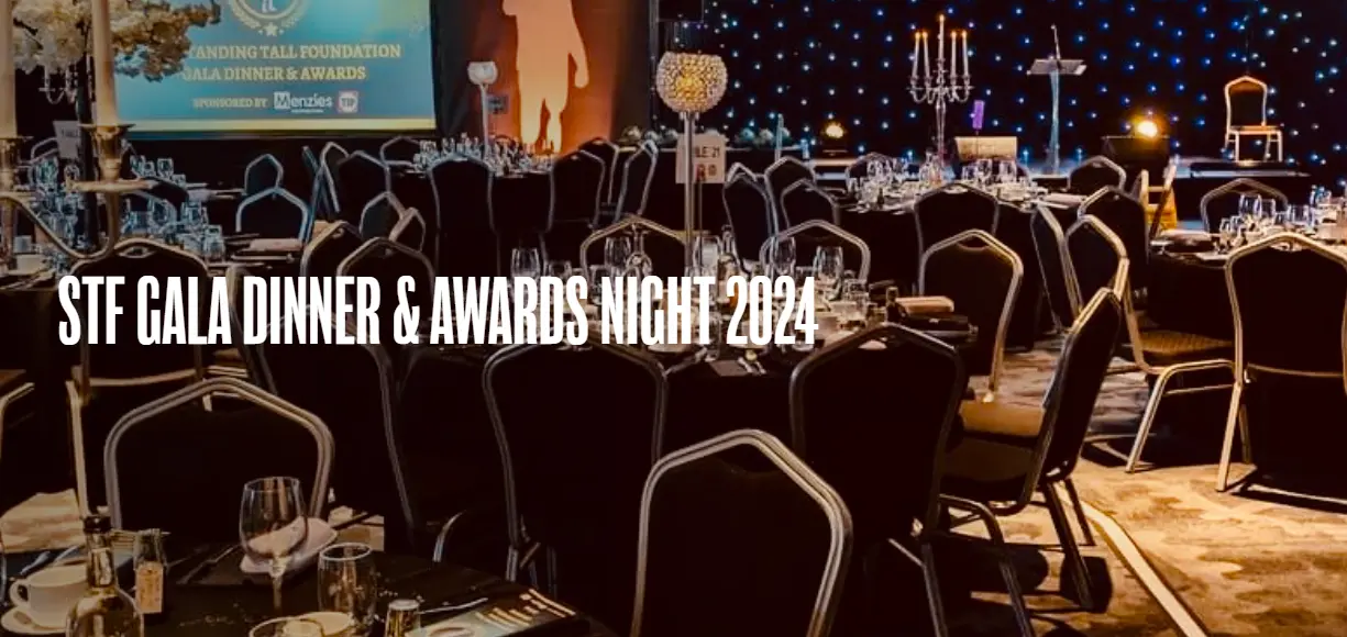 Awards dinner room with black and silver tables