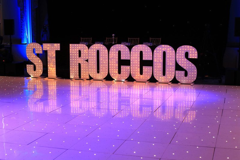 ST Roccos written in glitter shining on a spartkly dance floor