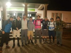 Team photo of eight hikers post-race