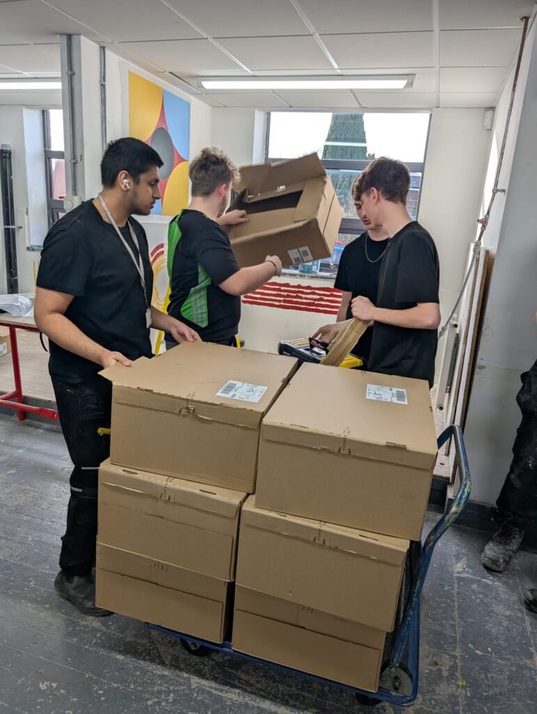 Large boxes with students opening them